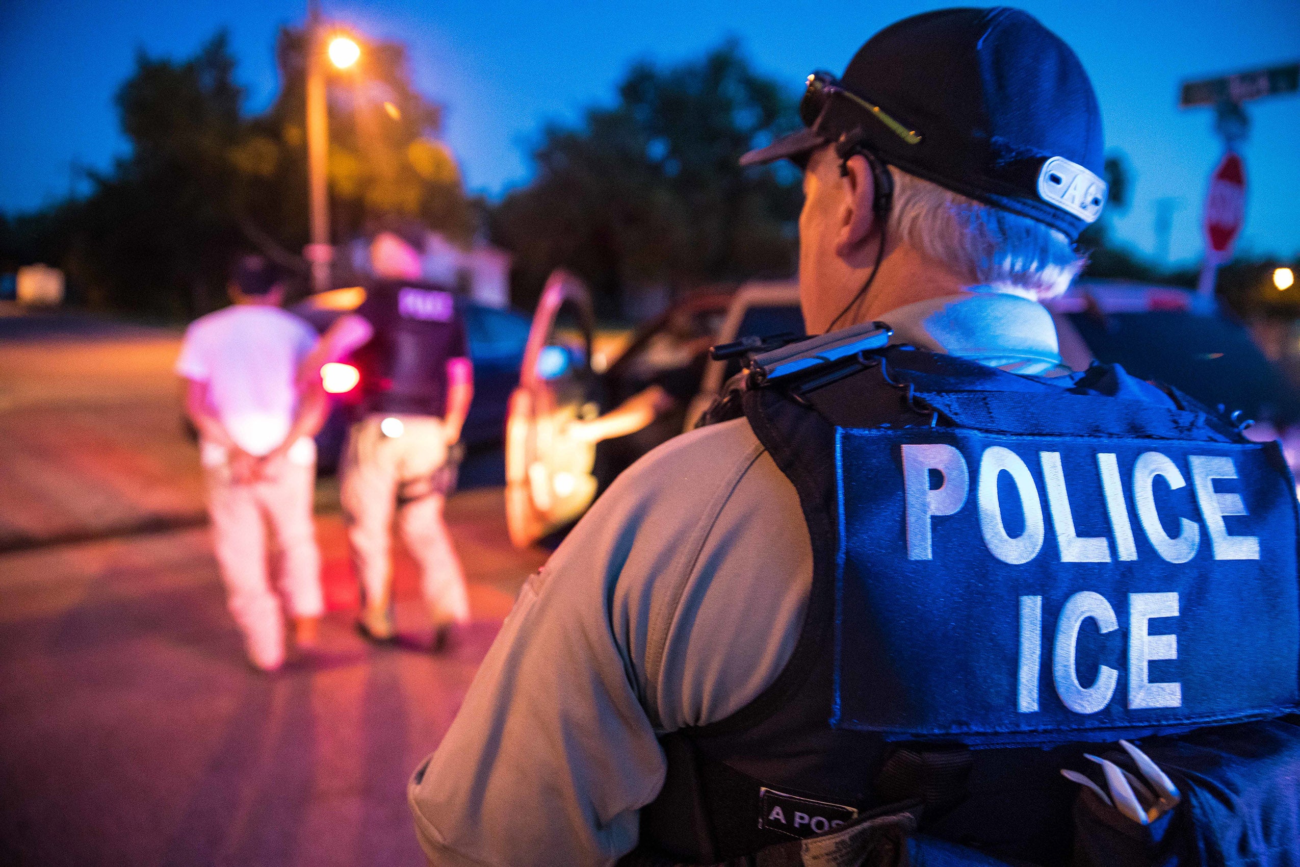 US Immigration and Customs Enforcement officers with detainee