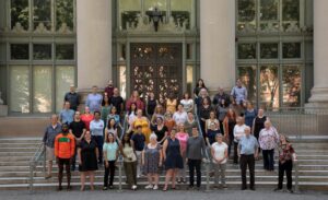 library staff posed in front of the Holmes field entrance of Langdell.