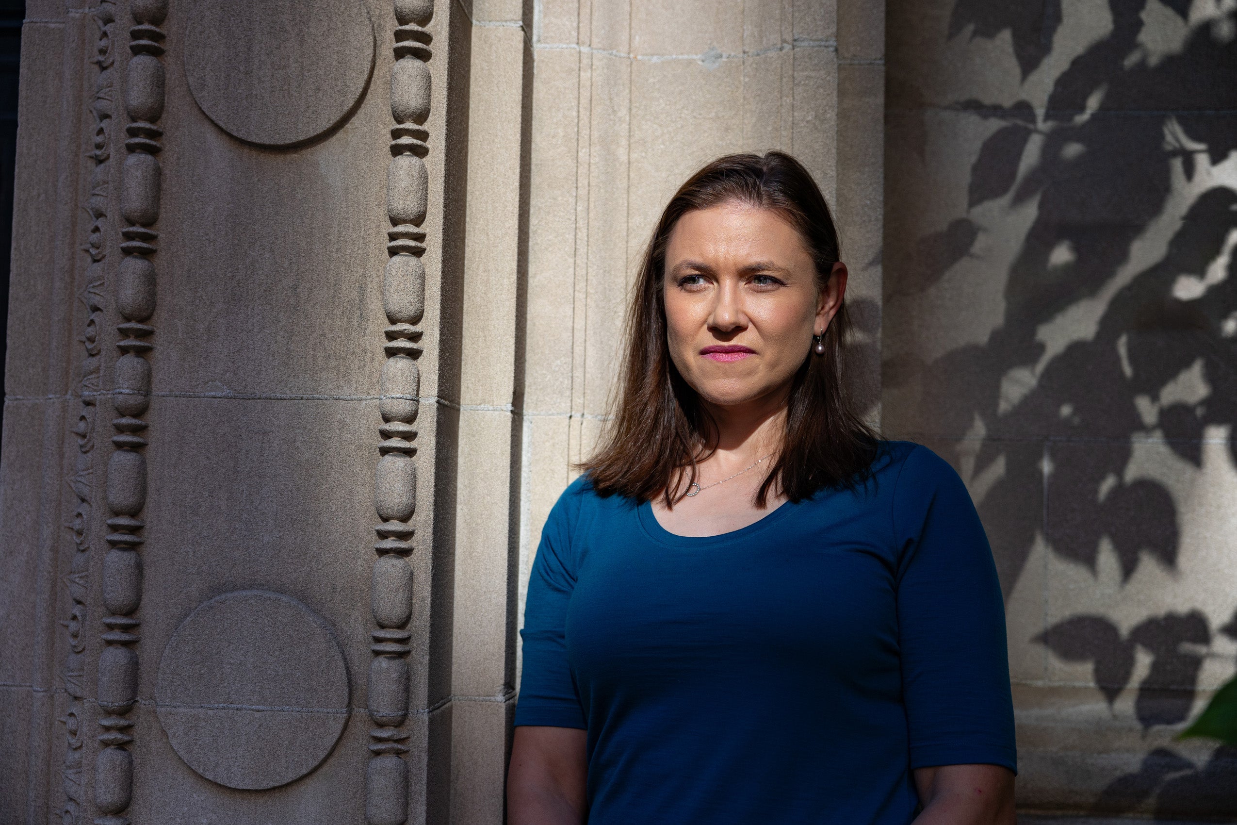 A portrait of Ruth Greenwood in front of a building