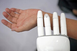 Robot checking human pulse.